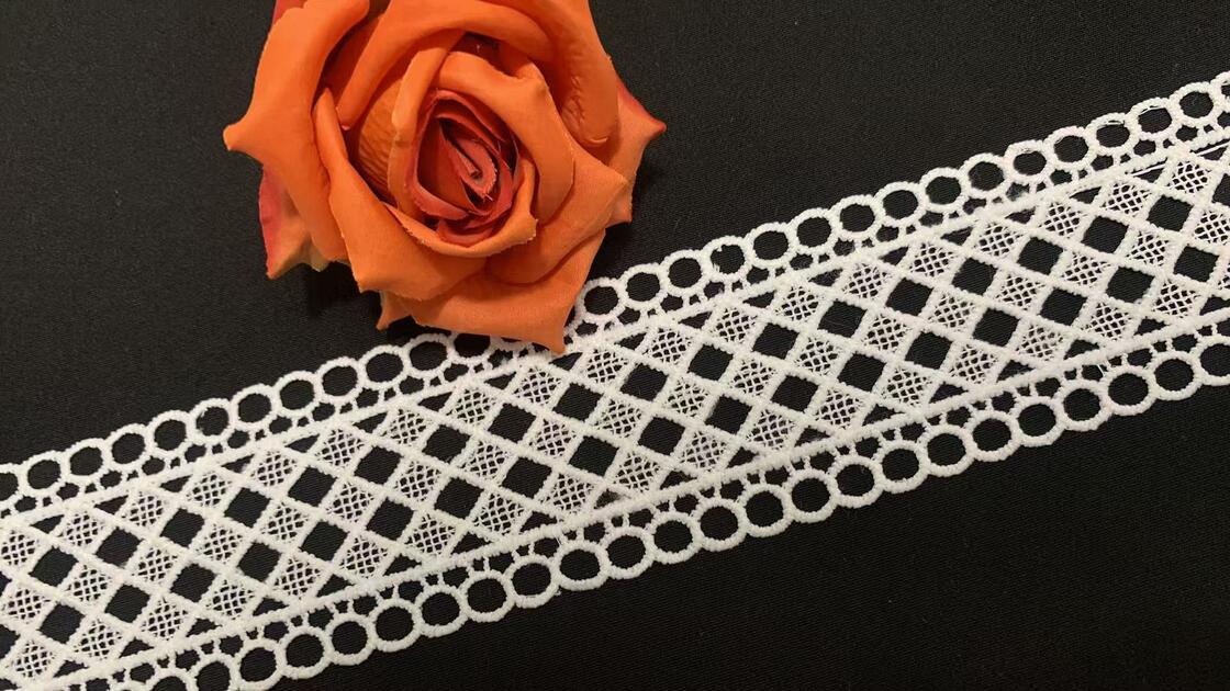 Quality 5.5cm Width Milk Yarn Lace Trim with Geometric Hollow Pattern and Neat Edge Stable Workmanship for Garment Decoration factory